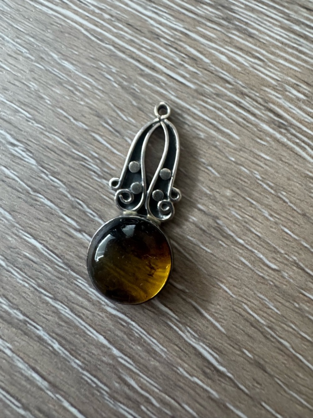Amber and 925 silver swirl design pendant